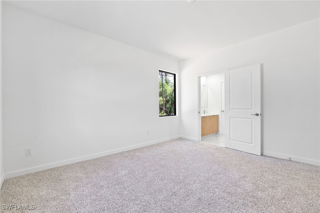 713 Wells Ave, Lehigh Acres, FL 33972 - empty room with baseboards and light carpet