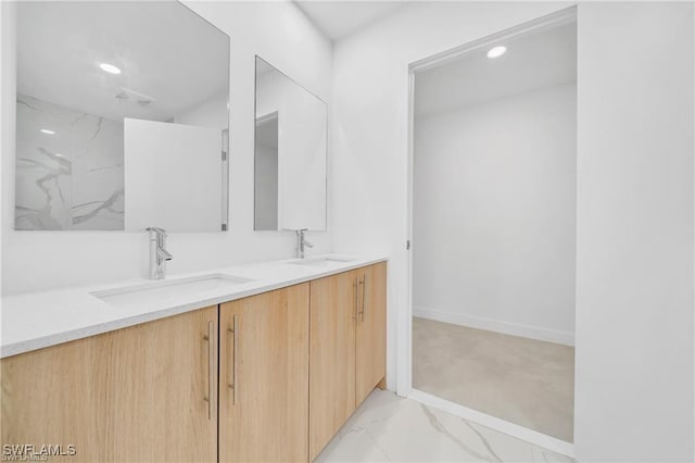 full bathroom with double vanity, marble finish flooring, recessed lighting, and baseboards