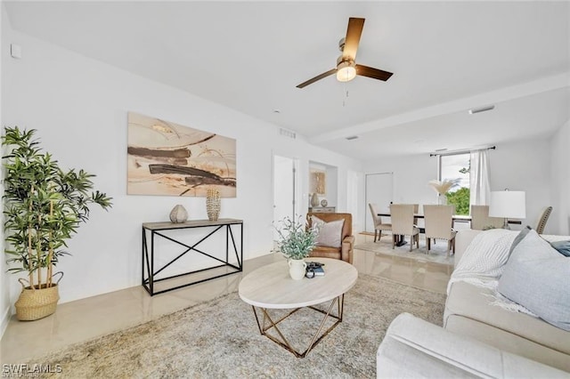 tiled living room featuring ceiling fan
