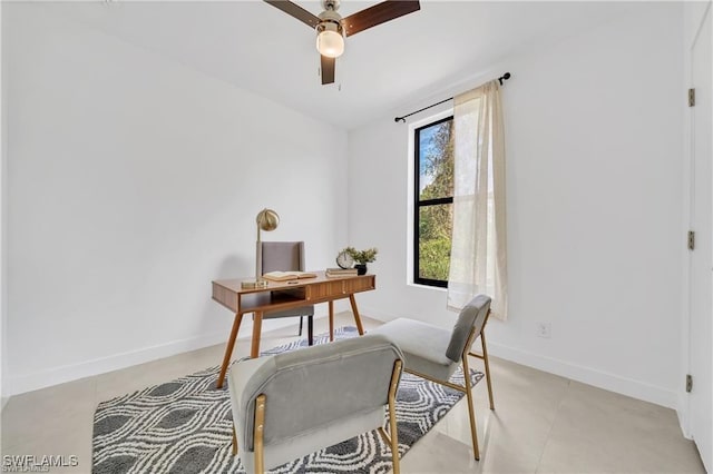 office area with a ceiling fan, baseboards, and light tile patterned floors