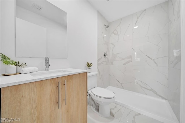 full bathroom with toilet, vanity, marble finish flooring, and a marble finish shower