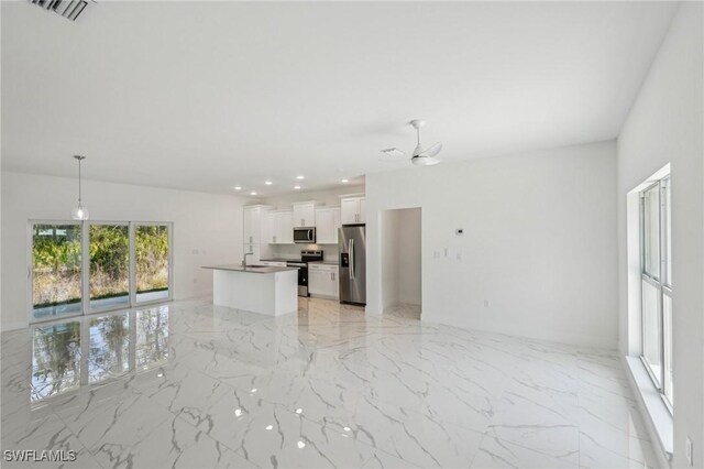 unfurnished living room with light marble finish flooring, a ceiling fan, a sink, and recessed lighting