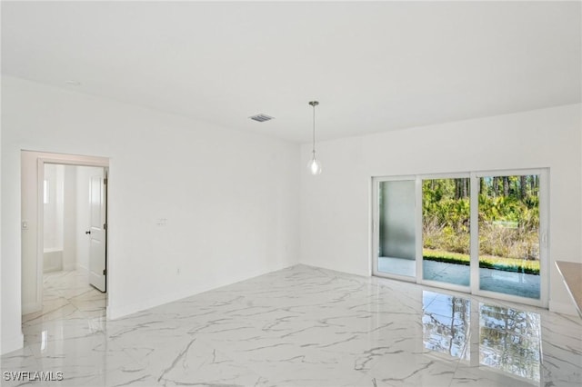 spare room with light marble finish floors and baseboards