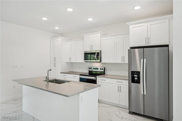 kitchen featuring appliances with stainless steel finishes, light marble finish floors, a sink, an island with sink, and recessed lighting