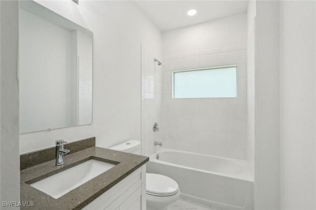 bathroom featuring toilet, shower / washtub combination, and vanity