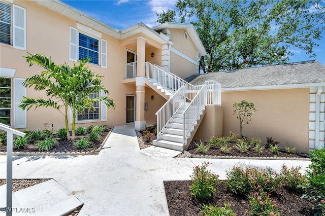 property entrance with stucco siding