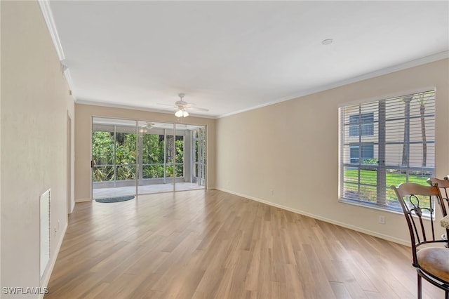 unfurnished living room featuring ornamental molding, light wood-style floors, baseboards, and ceiling fan