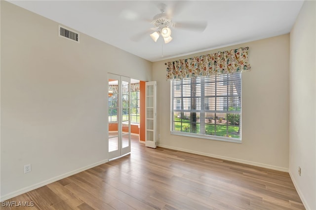 unfurnished room with a ceiling fan, baseboards, and wood finished floors