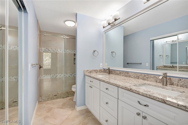 full bathroom featuring a shower stall, double vanity, toilet, and tile patterned floors
