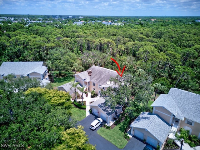 aerial view of residential area featuring a heavily wooded area