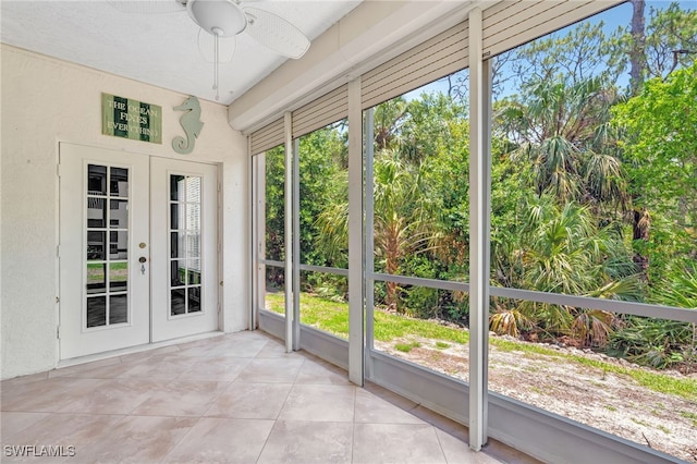 unfurnished sunroom with french doors, plenty of natural light, and a textured wall
