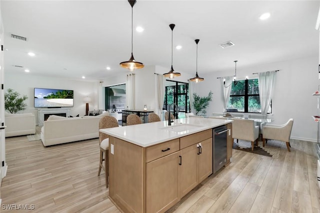 10427 Ventana Ln, Naples, FL 34120 - kitchen featuring a sink, light brown cabinetry, light wood-style floors, dishwasher, and recessed lighting