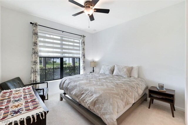 10427 Ventana Ln, Naples, FL 34120 - bedroom with light carpet, baseboards, and ceiling fan
