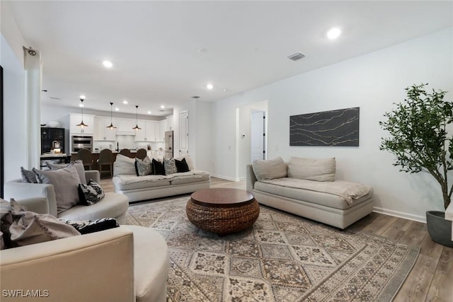 10427 Ventana Ln, Naples, FL 34120 - living room featuring wood finished floors, recessed lighting, and baseboards