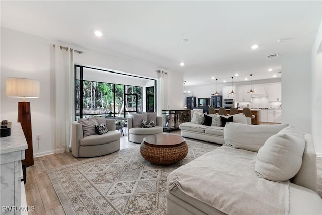 10427 Ventana Ln, Naples, FL 34120 - living area with light wood-style flooring, recessed lighting, and baseboards