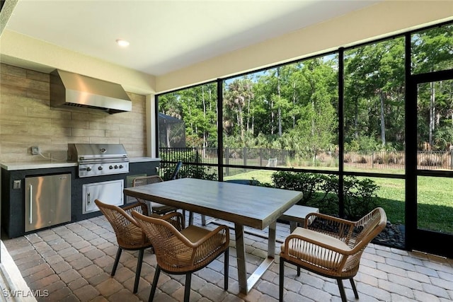 10427 Ventana Ln, Naples, FL 34120 - kitchen with wall chimney exhaust hood, fridge, recessed lighting, and light countertops