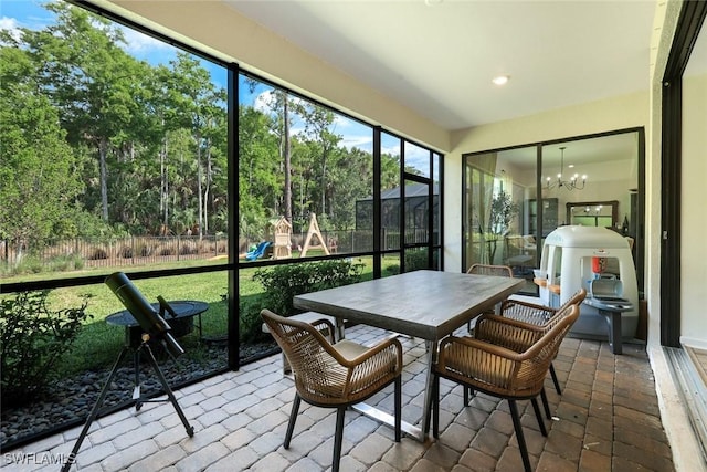 10427 Ventana Ln, Naples, FL 34120 - sunroom / solarium with a chandelier and outdoor dining space