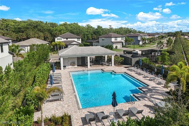 10427 Ventana Ln, Naples, FL 34120 - community pool featuring a patio area, fence, and a residential view