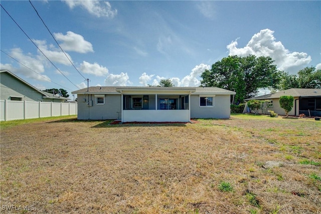 back of property featuring stucco siding and a sunroom