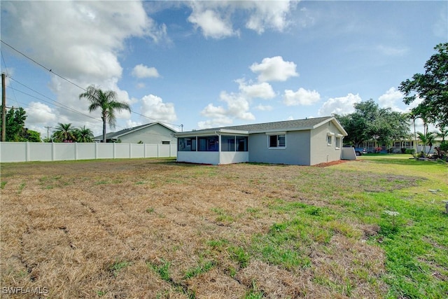 back of house featuring a sunroom and stucco siding