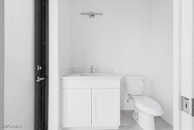 305 Diplomat Pkwy E, Cape Coral, FL 33909 - bathroom featuring toilet, vanity, baseboards, and tile patterned flooring