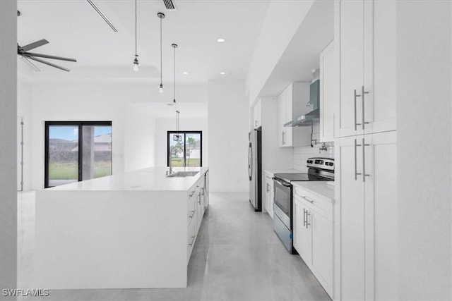 305 Diplomat Pkwy E, Cape Coral, FL 33909 - kitchen featuring stainless steel range with electric stovetop, wall chimney exhaust hood, refrigerator, a sink, and white cabinets