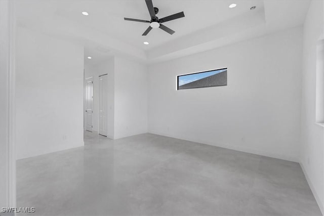 305 Diplomat Pkwy E, Cape Coral, FL 33909 - spare room with concrete floors, recessed lighting, a ceiling fan, and a tray ceiling