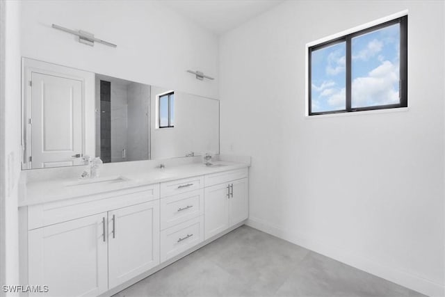 305 Diplomat Pkwy E, Cape Coral, FL 33909 - bathroom featuring double vanity, finished concrete flooring, baseboards, and a shower