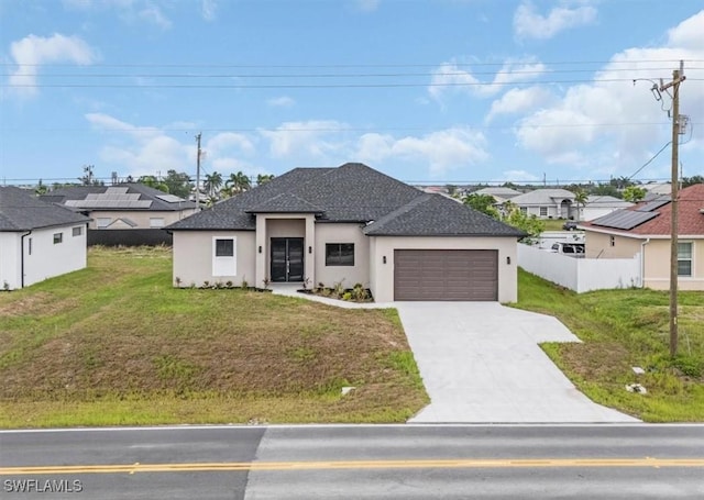 305 Diplomat Pkwy E, Cape Coral, FL 33909 - view of front of home featuring an attached garage, concrete driveway, stucco siding, and a shingled roof