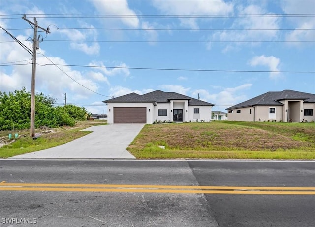 305 Diplomat Pkwy E, Cape Coral, FL 33909 - prairie-style house featuring driveway, an attached garage, stucco siding, and a front yard
