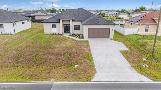 305 Diplomat Pkwy E, Cape Coral, FL 33909 - view of front of property with an attached garage, a residential view, concrete driveway, stucco siding, and a shingled roof