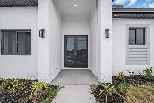 305 Diplomat Pkwy E, Cape Coral, FL 33909 - entrance to property with stucco siding and french doors