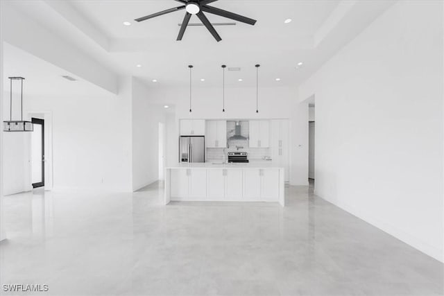 305 Diplomat Pkwy E, Cape Coral, FL 33909 - unfurnished living room with a ceiling fan, recessed lighting, concrete flooring, a high ceiling, and a raised ceiling