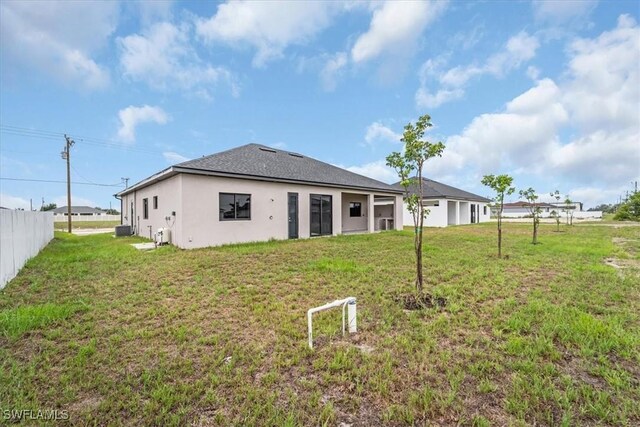 305 Diplomat Pkwy E, Cape Coral, FL 33909 - back of house featuring stucco siding