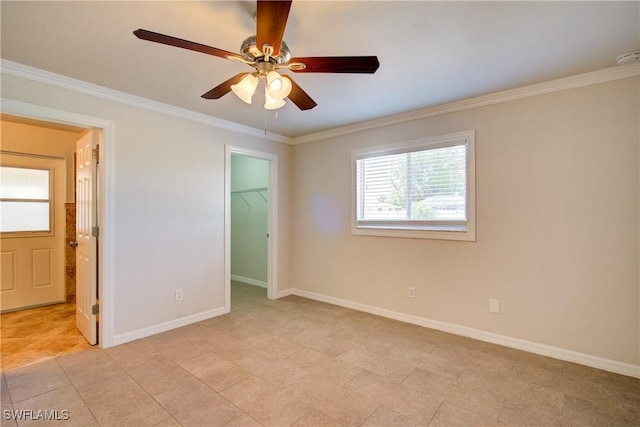 unfurnished bedroom with a walk in closet, crown molding, baseboards, connected bathroom, and a closet