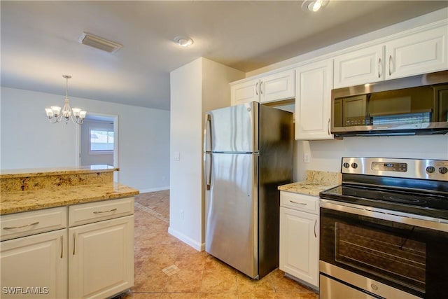 kitchen featuring stainless steel appliances, white cabinetry, hanging light fixtures, light stone counters, and a chandelier