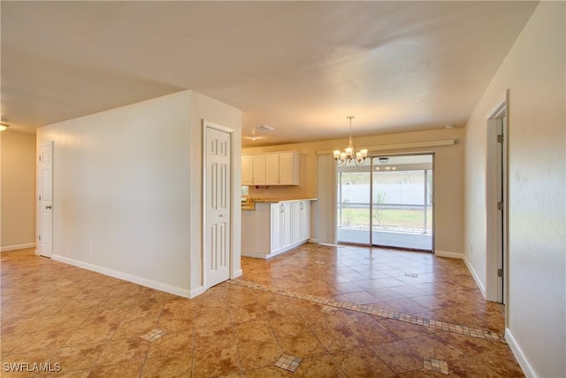 unfurnished dining area with a chandelier, light tile patterned flooring, baseboards, and inlaid floor details