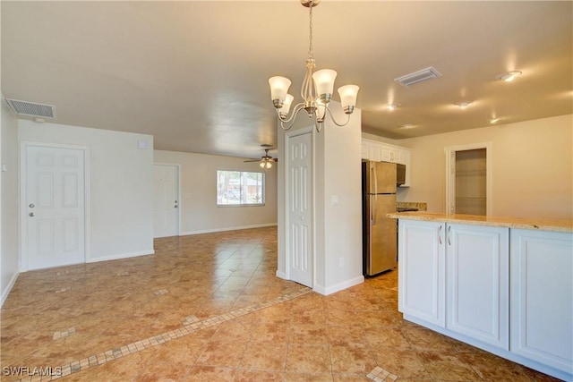 kitchen featuring freestanding refrigerator, light tile patterned flooring, ceiling fan, white cabinets, and baseboards