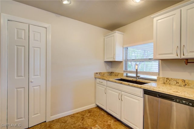 kitchen featuring dishwasher, a sink, white cabinets, light stone counters, and recessed lighting