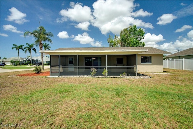 rear view of property with a sunroom