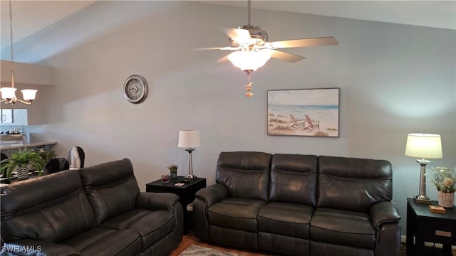 living area with a chandelier, vaulted ceiling, and ceiling fan