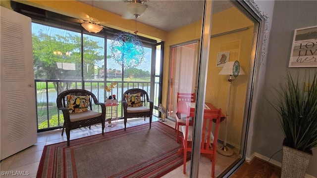 sunroom with healthy amount of natural light and a water view