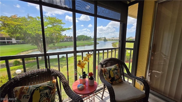 sunroom / solarium with a water view