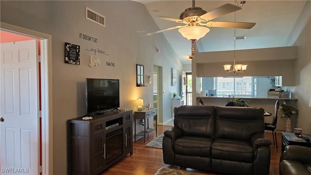 living area featuring dark wood finished floors, a chandelier, ceiling fan, and lofted ceiling