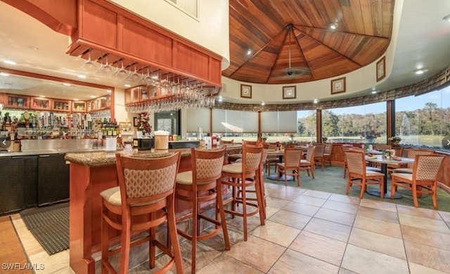 community bar area with wood ceiling and light tile patterned floors