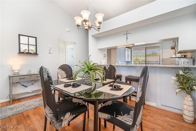 13090 Cross Creek Ct Unit 210, Fort Myers, FL 33912 - dining space with a chandelier, light wood finished floors, and high vaulted ceiling