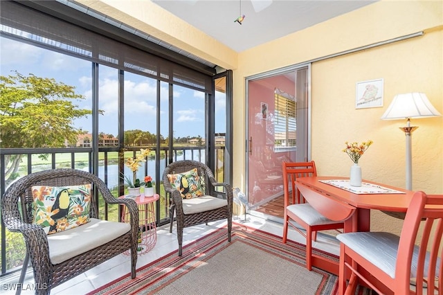 13090 Cross Creek Ct Unit 210, Fort Myers, FL 33912 - sunroom featuring a water view, a ceiling fan, and a textured wall
