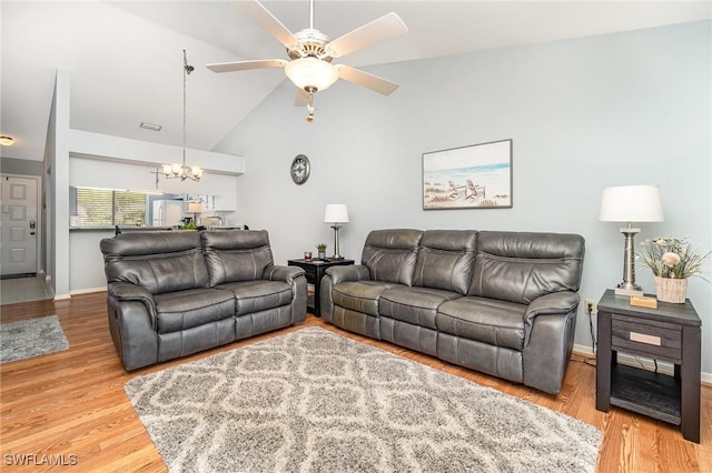 13090 Cross Creek Ct Unit 210, Fort Myers, FL 33912 - living room featuring a chandelier, a ceiling fan, wood finished floors, and high vaulted ceiling