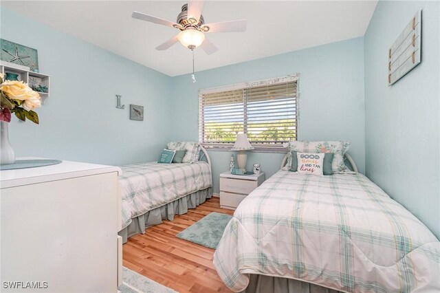 13090 Cross Creek Ct Unit 210, Fort Myers, FL 33912 - bedroom with wood finished floors, washer / clothes dryer, and a ceiling fan