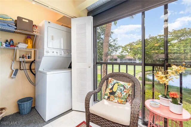 13090 Cross Creek Ct Unit 210, Fort Myers, FL 33912 - washroom with stacked washer and clothes dryer, healthy amount of natural light, and light tile patterned flooring